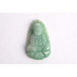 A carved Chinese jadeite pendant of a seated deity, of mottled pale green and white colour. 3.25cm