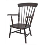 A 19th century Windsor chair, with high back and shaped seat and arm supports, on turned legs.