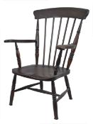 A 19th century Windsor chair, with high back and shaped seat and arm supports, on turned legs.