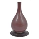 A small 19th century Chinese sang-de-beouf bottle vase, of pear form, covered in an even brown/red