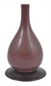 A small 19th century Chinese sang-de-beouf bottle vase, of pear form, covered in an even brown/red