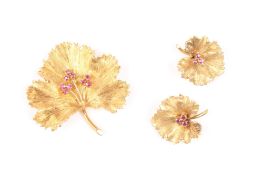 An 18ct gold and ruby earring and brooch set, probably Continental in the form of leaves set with