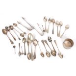 A collection of assorted silver spoons, predominantly teaspoons, together with sugar tongs and a