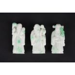 A collection of three nephrite carved figures of immortals, 20th century, of white colour with green