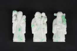 A collection of three nephrite carved figures of immortals, 20th century, of white colour with green