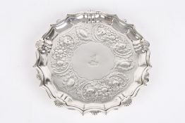A Victorian silver salver, hallmarked London, of fluted form with repoussé decoration of scrolls,