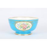A large Minton powder blue fruit bowl, painted with oval panels of flowers and rich gilt highlights,