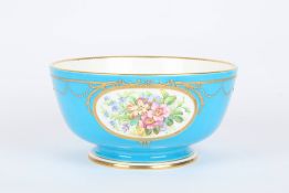 A large Minton powder blue fruit bowl, painted with oval panels of flowers and rich gilt highlights,