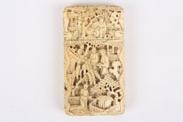 A miniature ivory Cantonese card case, the carved case depicting temples, figures and trees,