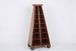 A walnut collectors cabinet, the open fronted cabinet of tapered form with 16 shelves raised on four