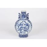 A late 19th century Chinese blue and white moon flask, decorated with large central panels of