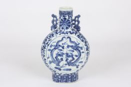 A late 19th century Chinese blue and white moon flask, decorated with large central panels of