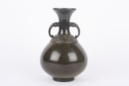 An early 20th century Chinese bronze vase, of bulbous form with mottled brown patina, the