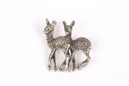 A white metal and marcasite double deer brooch, each with pale blue stone eyes, metal unmarked,