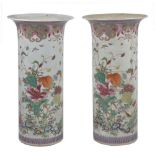 A pair of Chinese 18th century ‘famille-rose’ beaker vases, Yongzheng/Qianlong, each painted in rich