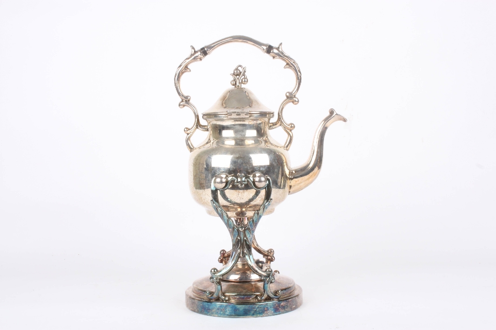 An early 20th century silver plated spirit kettle, supported on a scrolled stand with original