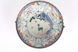 A 19th century Japanese Kakiemon bowl, with white metal mounted rim and pierced swing handle, the