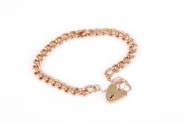 A rose gold curblink bracelet, with heart shaped yellow gold padlock clasp, stamped .375. 18cm long.