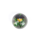A Baccarat pansy paperweight, circa 1850 the flower with purple and ochre coloured petals, with