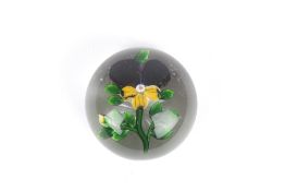 A Baccarat pansy paperweight, circa 1850 the flower with purple and ochre coloured petals, with