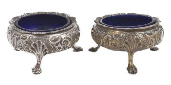 A pair of Victorian silver salts with blue glass liners, hallmarked London 1846, with floral