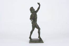 A patinated bronze figure of the Dancing Faun of Pompeii, the standing nude figure in mid stride on