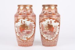 A large pair of late 19th century Japanese Imari vases, each decorated with a panels of a man riding