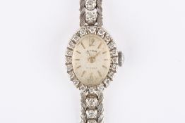 An Art Deco Cara 18ct gold and diamond ladies cocktail watch, the oval silvered dial with baton