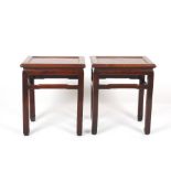 A pair of late 19th/early 20th century Chinese hardwood urn tables, the rectangular recessed tops