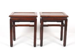 A pair of late 19th/early 20th century Chinese hardwood urn tables, the rectangular recessed tops