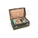 A ladies 1930s travelling vanity case, the canvas covered case opening up to reveal four glass,