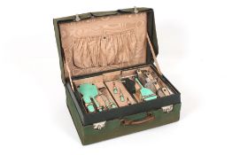 A ladies 1930s travelling vanity case, the canvas covered case opening up to reveal four glass,