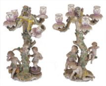 A pair late 19th/early 20th century Dresden porcelain four light candelabra, each modelled as