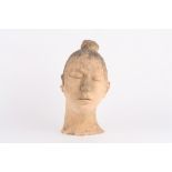 A Chinese Terracotta warriors head, realistically modelled with tilted head and hair tied in a