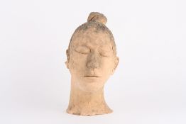 A Chinese Terracotta warriors head, realistically modelled with tilted head and hair tied in a