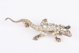 A Continental silver gilt lizard brooch, realistically modelled and studded with rows of paste