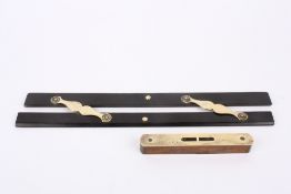 A 19th century ebony parallel rule, with brass hinges, together with an associated brass and oak