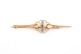 A 9ct gold and sapphire bar brooch, formed as three stacked sapphires mounted on a shaped bar, in