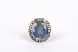 An 18ct white gold sapphire and diamond dress ring, set with centre pale blue oval faceted