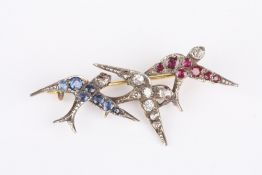 An Edwardian diamond, sapphire and ruby triple bar brooch, set with three swallows, each set with