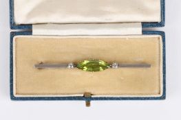 An Art Deco peridot and diamond bar brooch, set with large marquise shaped peridot with a diamond