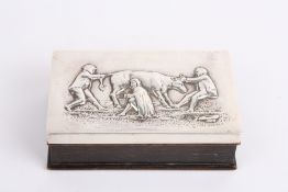 A rectangular silver topped box with repoussé milking scene, hallmarked London 1929, with makers