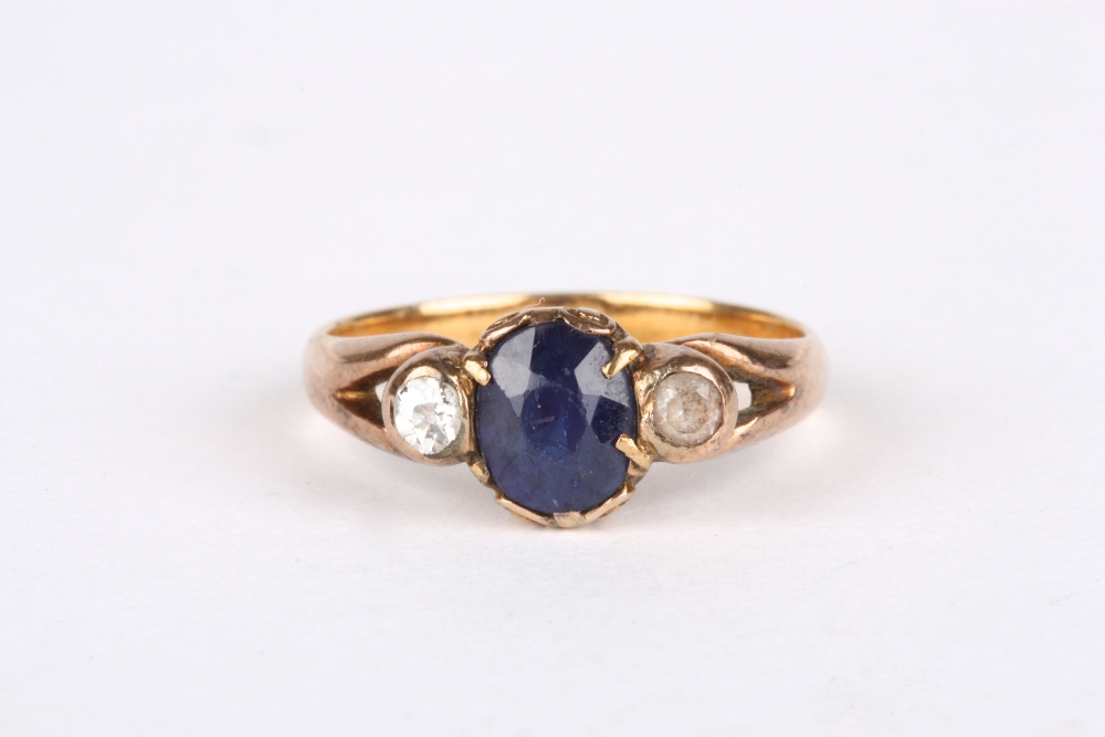 An 18ct gold, sapphire and diamond ring, set with oval sapphire flanked either side by a diamond