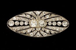 An Art Deco platinum and diamond oval brooch, set with two large central diamonds of approximately