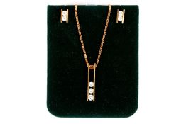 A gold and diamond necklace and earrings, the necklace formed as two parallel bars holding three