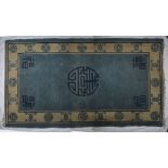 A Chinese rug, the blue rug of rectangular form with Chinese characters, 200cm long, 123cm wide .