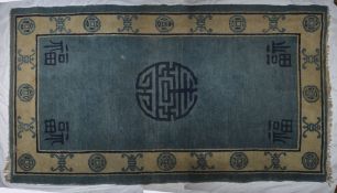 A Chinese rug, the blue rug of rectangular form with Chinese characters, 200cm long, 123cm wide .