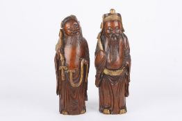 A large pair of 19th century Chinese carved bamboo figures of elders, each decorated with gilt