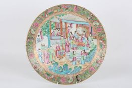 A large Chinese famille rose circular charger, circa 1900, decorated with a large central scene of