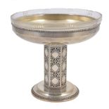 A Secessionist style silver plated comport, early 20th century, with glass liner supported on a